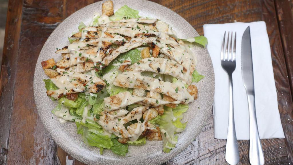 Caesar Salad · Romaine lettuce with Romano cheese, garlic herbed croutons and homemade Caesar dressing.
