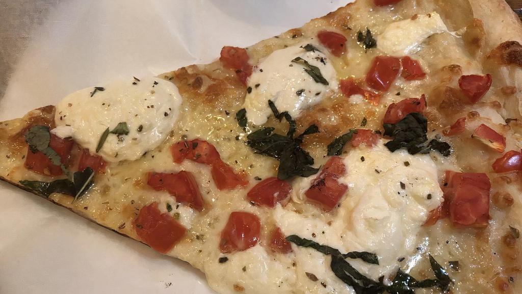 Caprese Pizza · Crispy round pie with fresh mozzarella, sliced tomatoes, and fresh basil. Drizzled with extra virgin olive oil and balsamic glaze.