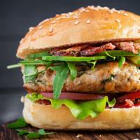 Turkey Burger · Fresh off the grill Turkey Burger topped with lettuce, tomato, and onion.