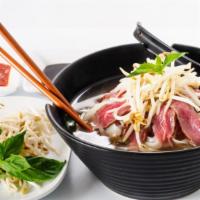 Pho Bo Beef · Traditional Vietnamese soup with tender beef along with noodles, locally grown veggies, and ...