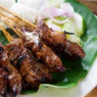 Beef Satay · Beef skewers served with peanut sauce and cucumber salad.