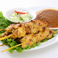 Chicken Satay · Chicken skewers served with peanut sauce and cucumber salad.