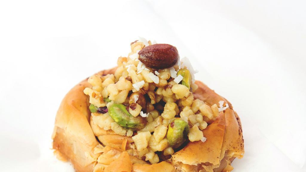 Mabrumeh · Twisted film dough topped with mixed nuts including pistachios, walnuts and almonds.