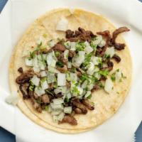 Carne Asada Taco · Soft tortilla filled with carne asada (steak) and topped with onions and cilantro, served wi...
