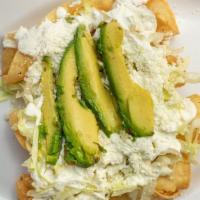 Flautas · Four fried tortilla rolls, topped with lettuce, sour cream, ground cojita cheese, and avocad...