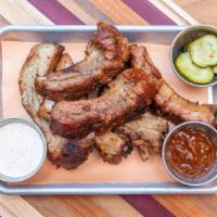 Baby Back Ribs · Dry rubbed pork ribs smoked 5 hours over apple wood. Includes: BBQ sauce  Half rack (6 ribs)...