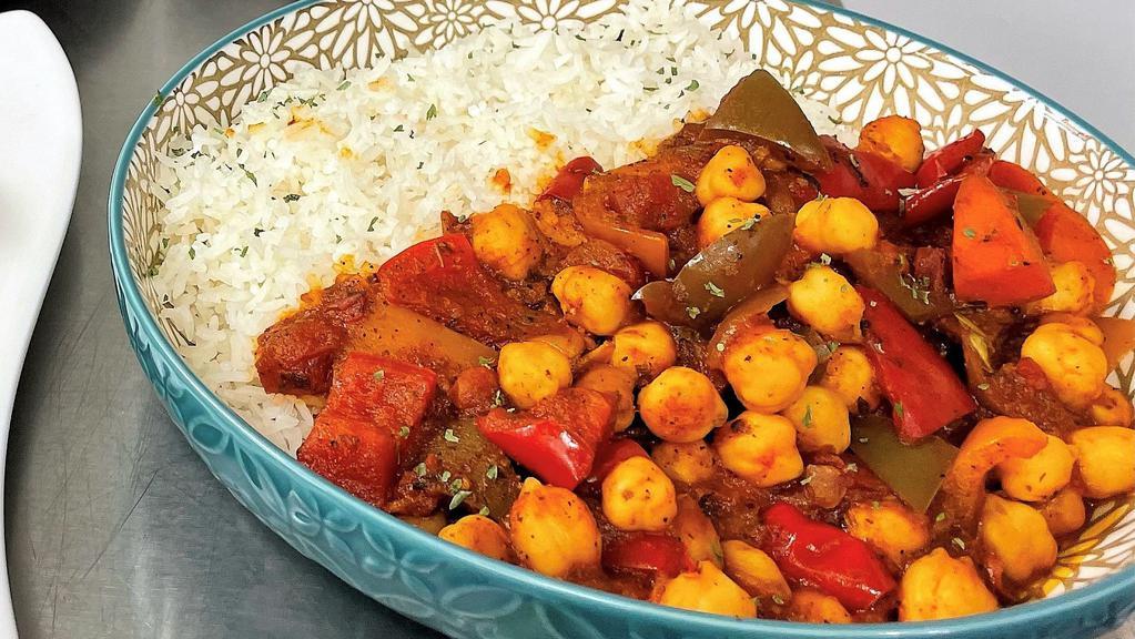 Caribbean Vegetable Stew · This tomato-based stewed dish is full of Caribbean flavors,  sautéed chick peas, cauliflower and garden-fresh vegetables. Gluten free.