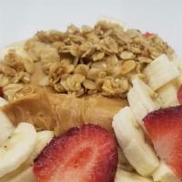 Peanut Butter Acai Bowl · Organic Acai blended with banana, peanut butter and almond milk. Topped with granola, strawb...