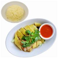 Hainanese Chicken Over Rice 海南鸡饭 · Slow poached free range bone-in chicken, cucumbers, chef's fragrant soy sauce and chili garl...