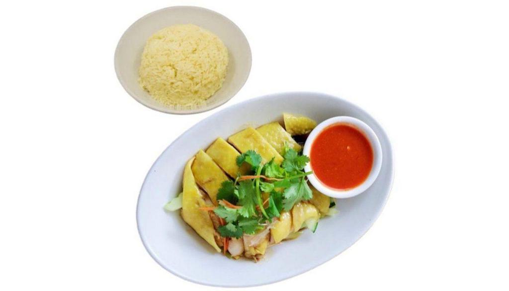 Hainanese Chicken Over Rice 海南鸡饭 · Slow poached free range bone-in chicken, cucumbers, chef's fragrant soy sauce and chili garlic sauce. Served room temperature. (buyers please beware)