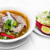 Bun Bo Hue · Spicy lemongrass infused noodle soup with beef, pork shank, fresh herb.