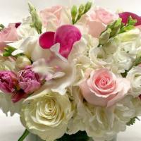 Pastel Dream · Soft pastels with a dash of fuchsia, cymbidium orchids, calla lilies, roses, tulips, and hyd...