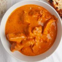 Butter Chicken · Sliced tandoori chicken with a rich creamy tomato sauce. Served with basmati rice.