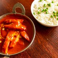 Chicken Jalfrezi · Strips of Chicken marinated in fresh ground spices cooked with Tomatoes, Onions & Bell peppers
