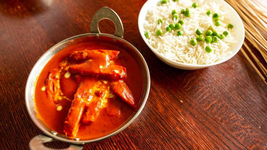 Chicken Jalfrezi · Strips of Chicken marinated in fresh ground spices cooked with Tomatoes, Onions & Bell peppers