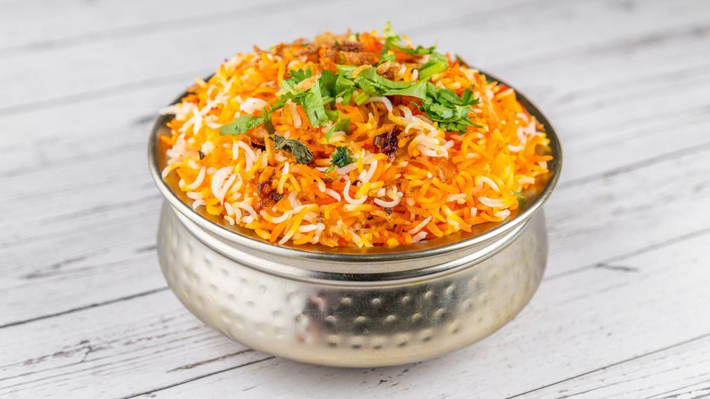 Chicken Biryani · Basmati Rice Cooked with Chicken mixed with Onion, Cashew Nuts and Raisins flavored with Saffron and delicate spices