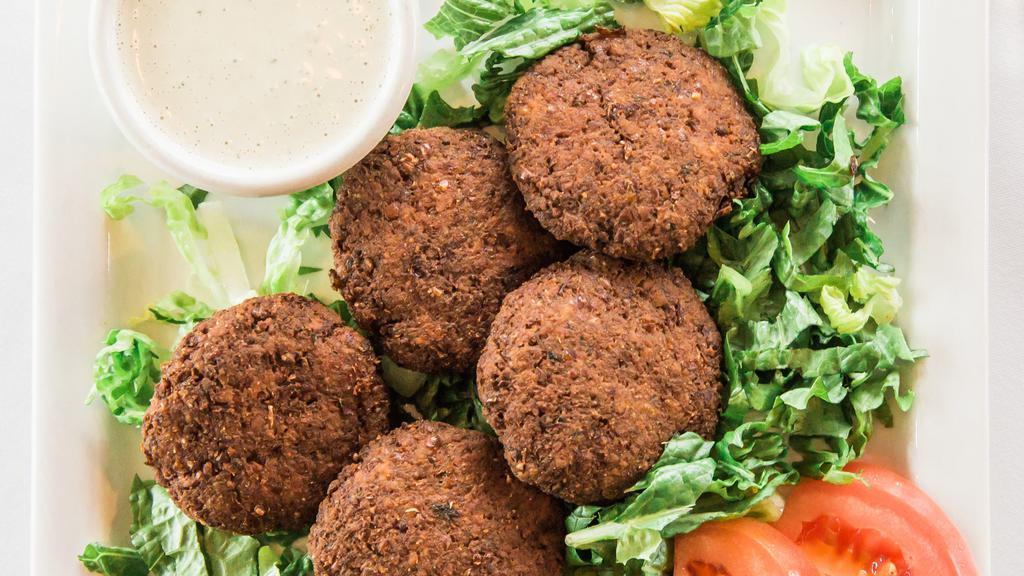 Falafel · Chickpeas and broad beans tossed in spices and deep fried.