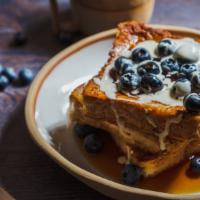 3 Slices Of French Toast With Blueberries · 3 Perfectly cooked French Toast slices, topped with fresh blueberries.