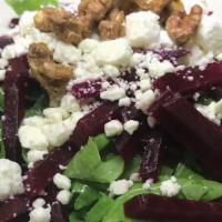 Baby Arugula, Red Beets · Feta cheese citrus emulsion and candied walnuts.