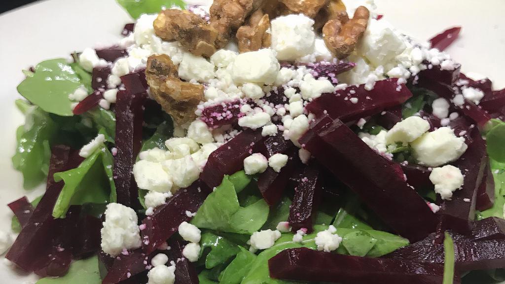 Baby Arugula, Red Beets · Feta cheese citrus emulsion and candied walnuts.
