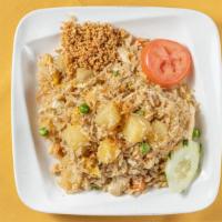 Pineapple Coconut Fried Rice · Coconut fried rice with chicken topped with ground peanut and fried onions.