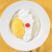 Kao Niew Ma-Muang · Fresh mango with sweet sticky rice topped with coconut milk.