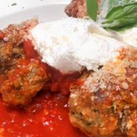 Grandmas Meatballs · Classic Italian meatballs cooked in tomato basil sauce and topped with ricotta cheese and pa...