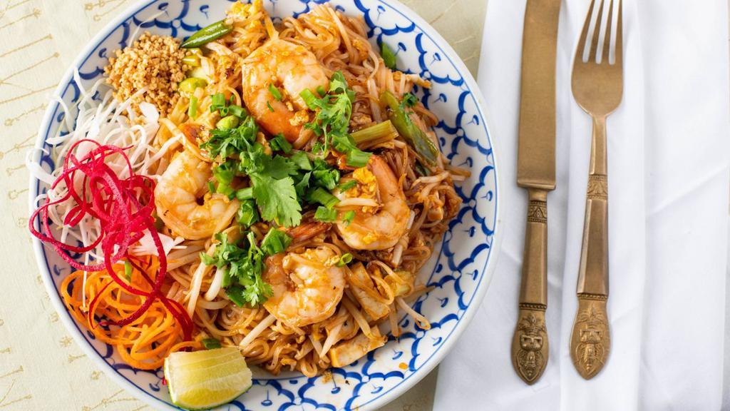 Pad Thai · Stir-fried rice noodles tossed with shrimp, egg, firm tofu, bean sprout topped with ground peanut.