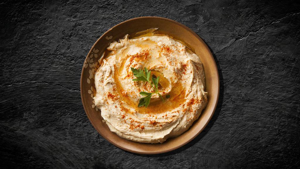 Classic Chickpea Hummus · Chickpeas boiled till soft, mashed, blended, and mixed with tahini, garlic, and lemon juice, topped with olive oil