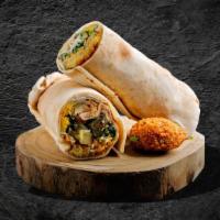 Ultimate Falafel Sandwich · Falafel served in a pita wrapped in a flatbread topped with tahini sauce, falafel, hummus, a...