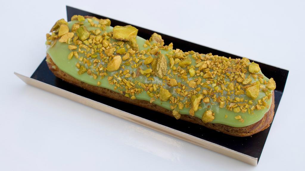 Eclair  Pistachio · Pistachio pastry cream with pistachio glaze topped in gold pistachios.