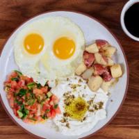 Israeli Breakfast · Two eggs, Labneh cheese, home fries, Israeli salad & pita.