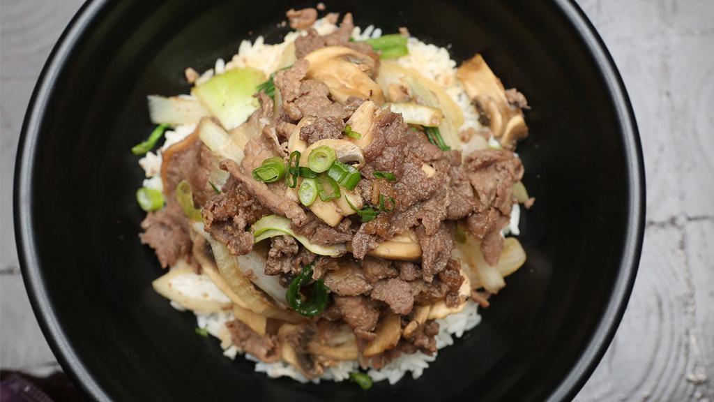Bulgogi Rice Bowl · Steamed white rice topped with marinated rib-eye beef and vegetables. Served with miso soup on the side.