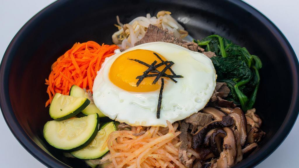 Bibimbap · Steamed white rice with assorted vegetables, ground beef, and topped with fried egg with spicy red pepper sauce on the side. Served with miso soup on the side.