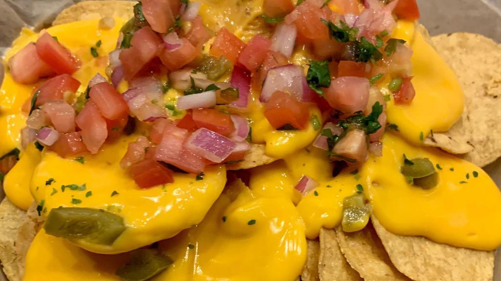 Nachos · Nacho chips with melted cheddar cheese, jalapeno peppers, and pico de gallo