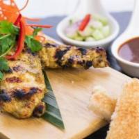 Chicken Satay (2 Skewers) · Savory chicken marinated in yellow curry powder and coconut milk. Served with our famous pea...