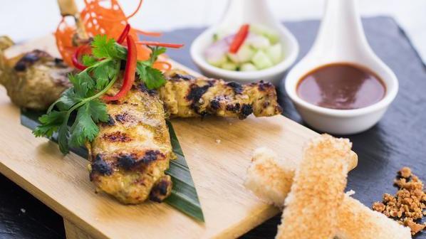 Chicken Satay (2 Skewers) · Savory chicken marinated in yellow curry powder and coconut milk. Served with our famous peanut sauce, cucumber salad, and toasted bread.