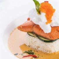 Salmon Curry · Grilled salmon filet atop jasmine rice, cucumber, and our signature red curry which includes...