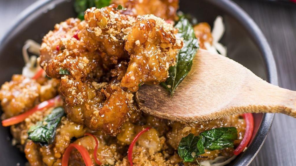 Crispy Garlic Chicken · Popular. Our house specialty. Lightly battered and fried boneless chicken pieces, stir fried in a sweet, garlic-infused sauce topped with crispy fried basil leaves and red bell peppers.