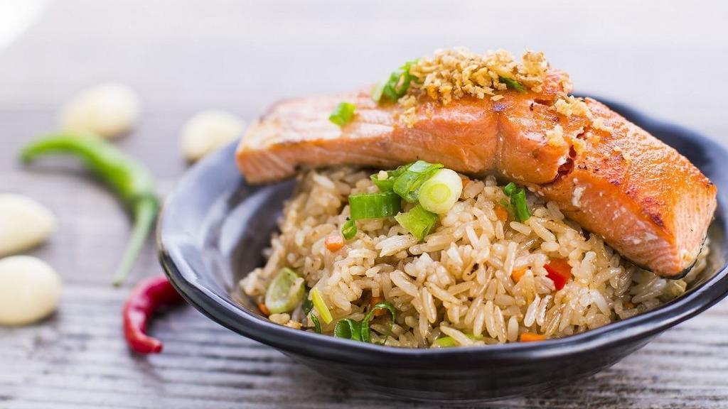 Salmon Garlic Fried Rice · Spicy. Jasmine rice stir fried in flavorful garlic paste, red bell pepper, carrot, and green onions. Topped with grilled garlic butter salmon fillet.