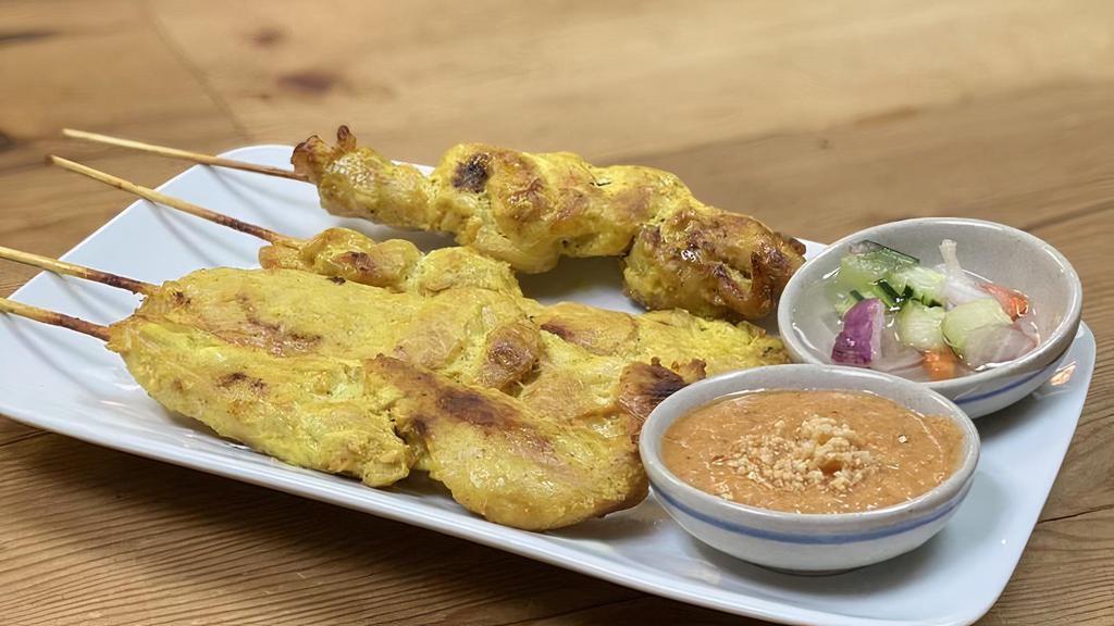 Chicken Satay · Grilled marinated chicken skewers served with peanut sauce and cucumber vinaigrette.