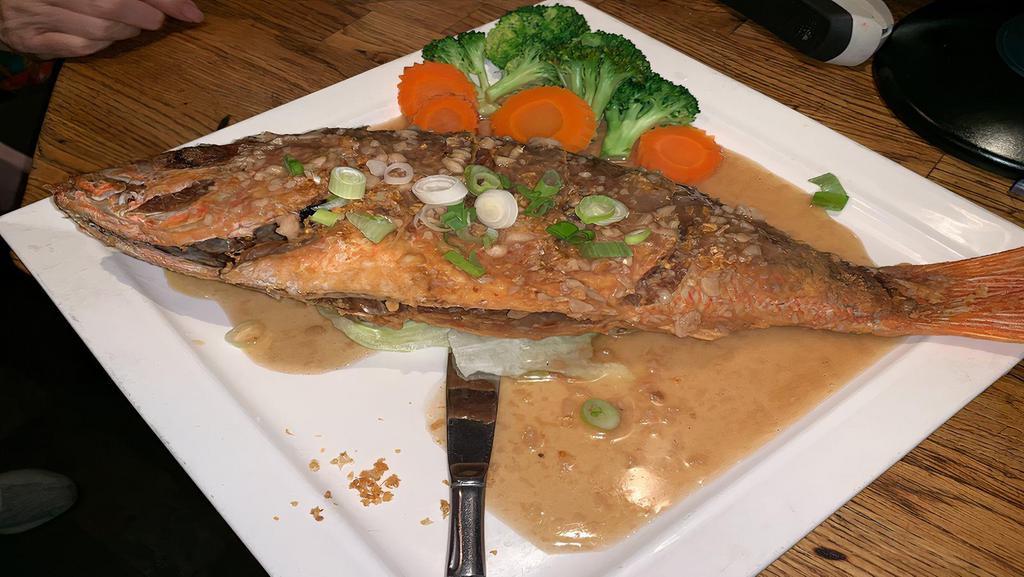 Pla=Crispy Garlic Red Snapper · Crispy red snapper topped with garlic sauce.