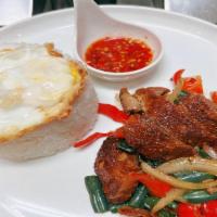 Ka Pao Ped · *Duck Basil Over Rice*
Crispy duck with fried egg over rice onion, bell pepper and basil lea...
