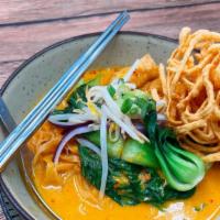 Cs02=Khao Soi (Egg Noodle Curry) · Egg noodles with yellow curry, mixed with red onions, scallions, bean sprouts, and bok choy.