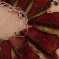 Pepper Tuna · Seared pepper encrusted tuna thinly sliced with yuzu wasabi sauce, fresh cucumber.