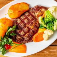 Rib-Eye Steak (14 Oz) · Served with roasted potatoes and sauteed veggies.