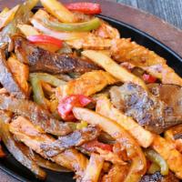 Saltado Churrasco · Grilled skirt steak, sautéed in red and green peppers, onions, fries and our special house m...