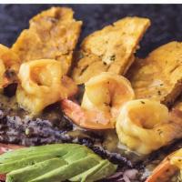 Mar & Tierra · Grilled skirt steak topped with garlic shrimp and served with mashed green plantains and hou...