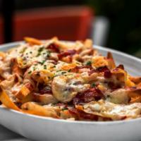 Loaded Fries · Traditionally prepared dish of French fries, topped with melted cheese, diced onions, sliced...