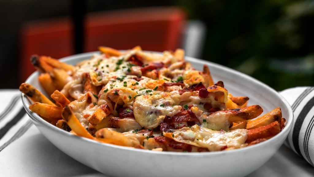 Loaded Fries · Traditionally prepared dish of French fries, topped with melted cheese, diced onions, sliced jalapeños, crispy bacon, and cool sour cream.